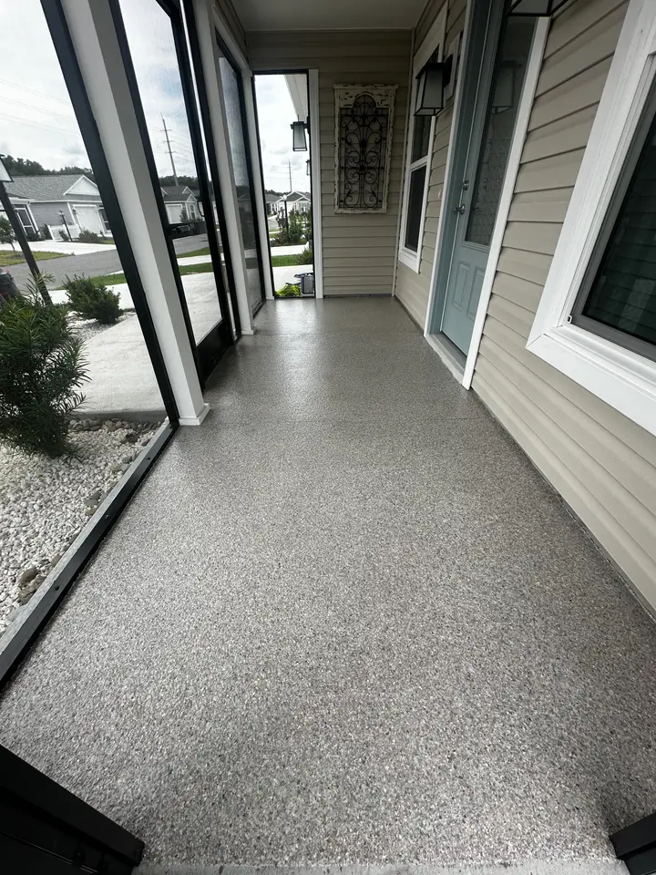 Decorative flake patio coating along a home exterior